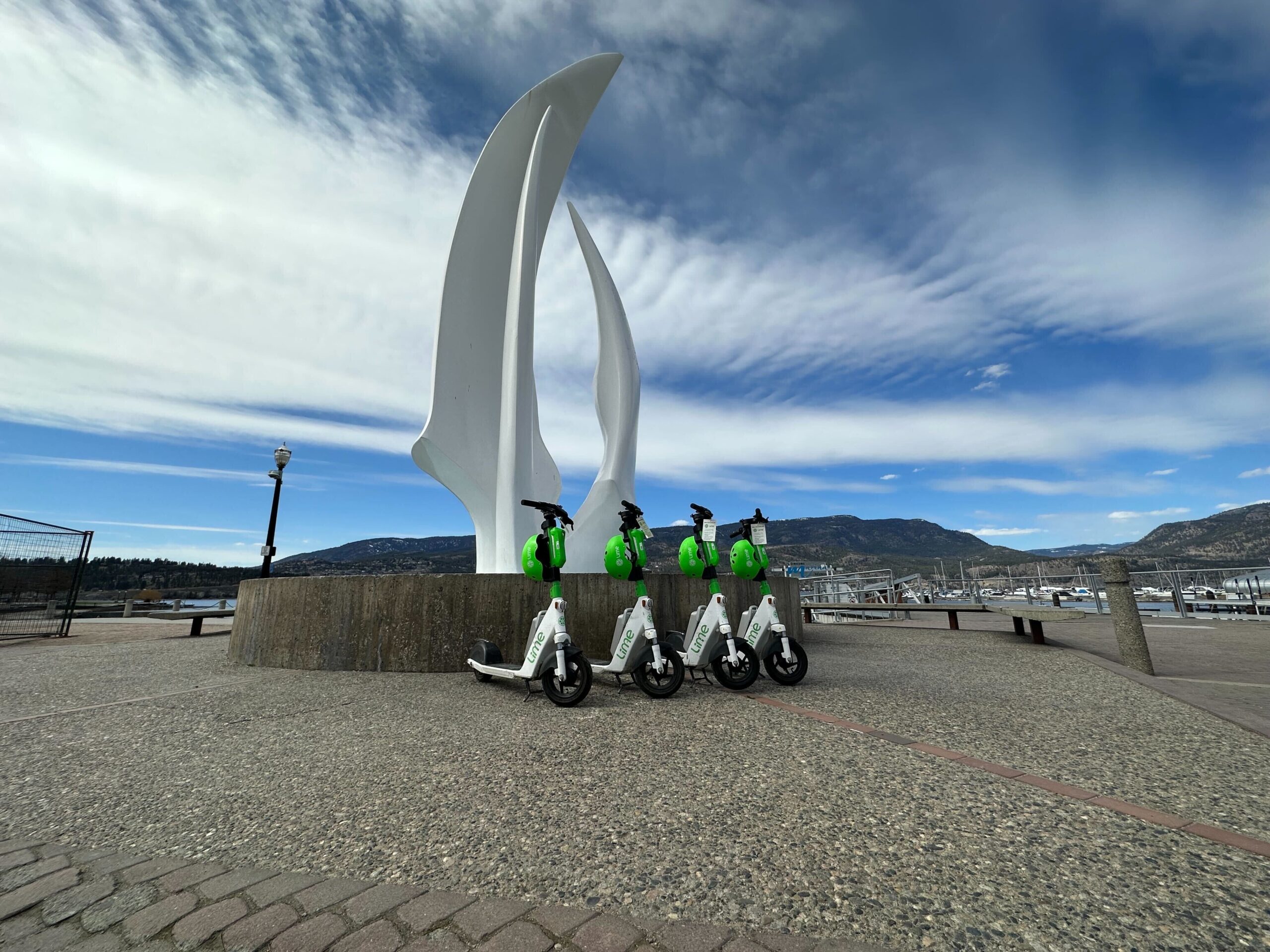 electric scooters parked by kelowna sails landmark
